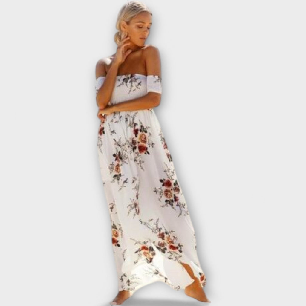 A white floral fluid midi dress with a gentle boho print, styled for a relaxed summer outing
