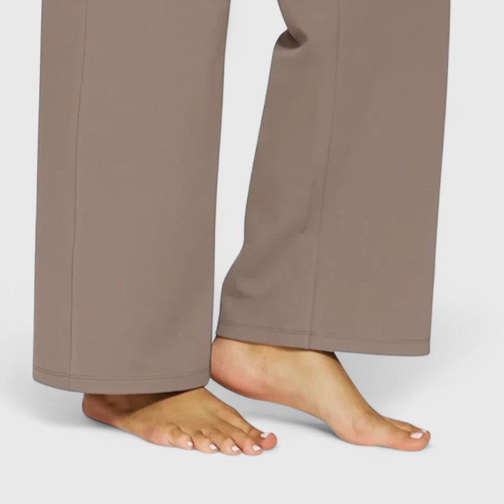 Woman wearing pull-on trousers with a soft blouse, relaxed and comfortable at home.