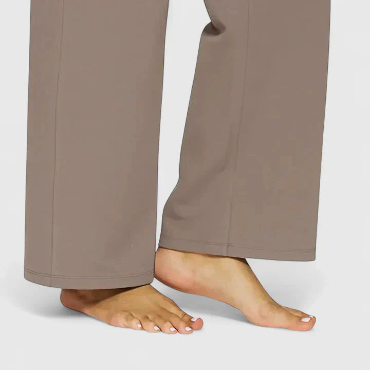 A woman in elegant straight-leg trousers with pockets, styled for a polished everyday look.