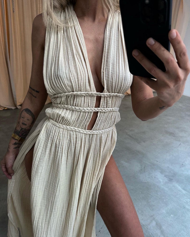 Woman in a softly textured dress with front slit and cinched waist tie at golden hour.
