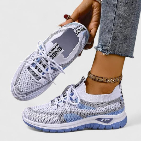 A woman lacing up light, breathable orthopaedic trainers before a walk.
