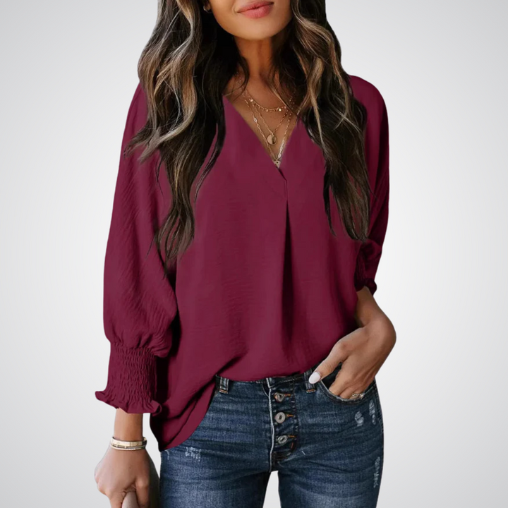 Apricot V-neck tunic blouse with gently ruched flutter sleeves and a flowing relaxed fit