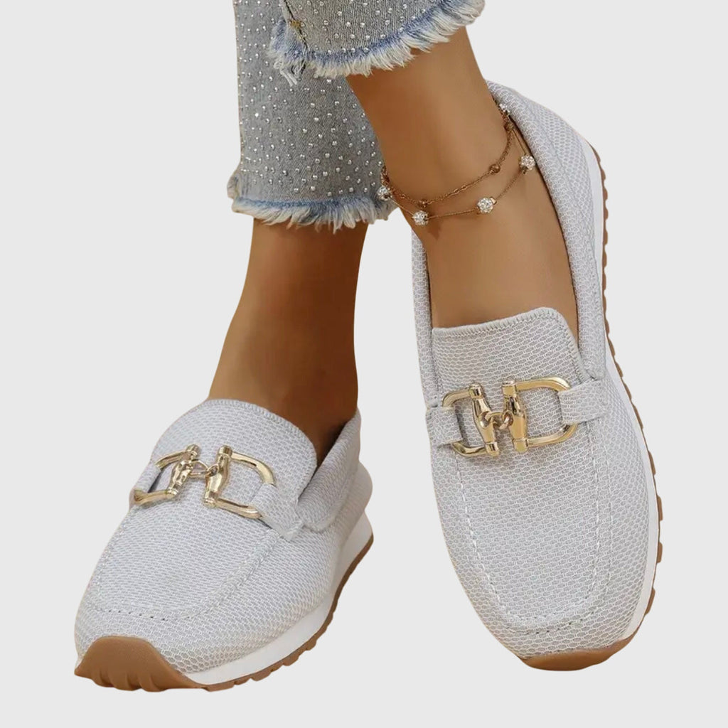 Women's beige comfort slip-on trainers with a cushioned sole and elegant metallic detail