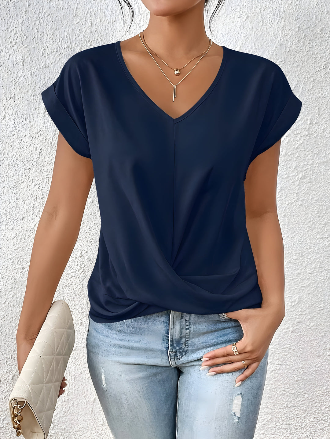 Pink V-neck top with a crossover-front detail and a relaxed, flattering silhouette