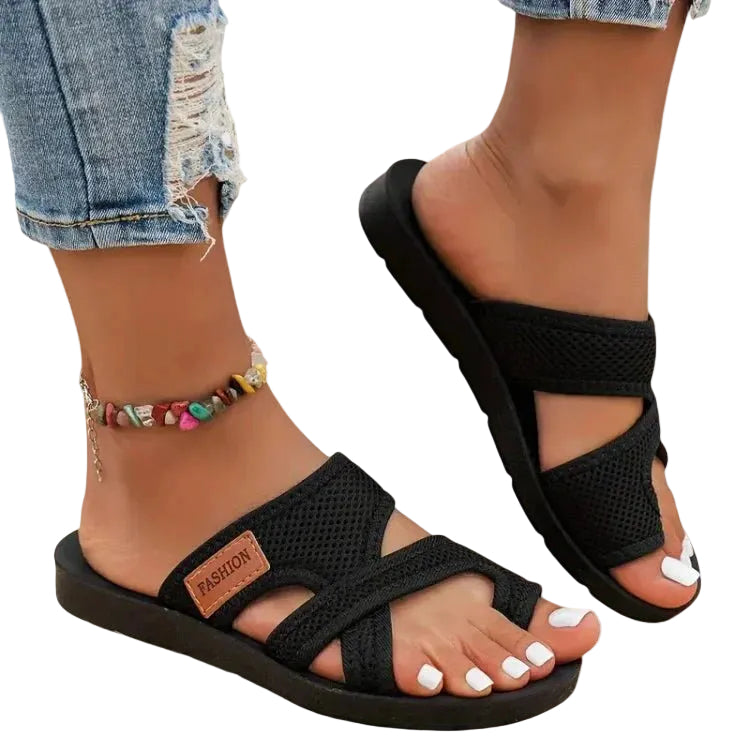 Lightweight flat sandal in black, also available in red and brown, with a simple clean design