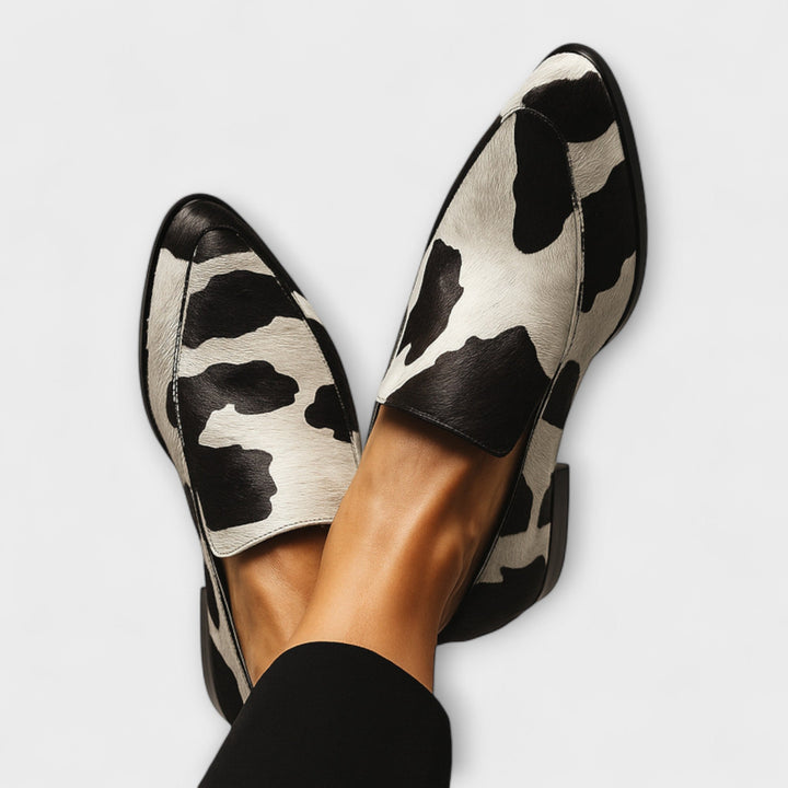 A woman wearing contemporary loafers with a modern, put-together outfit