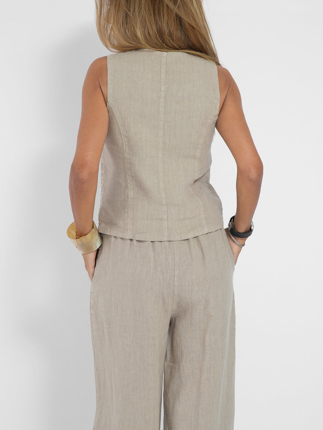 A woman wearing a tailored waistcoat with flowing wide-leg trousers