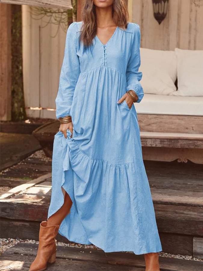 Woman walking through the countryside in the Georgia floral maxi dress with long sleeves and a flowing flounced hem.