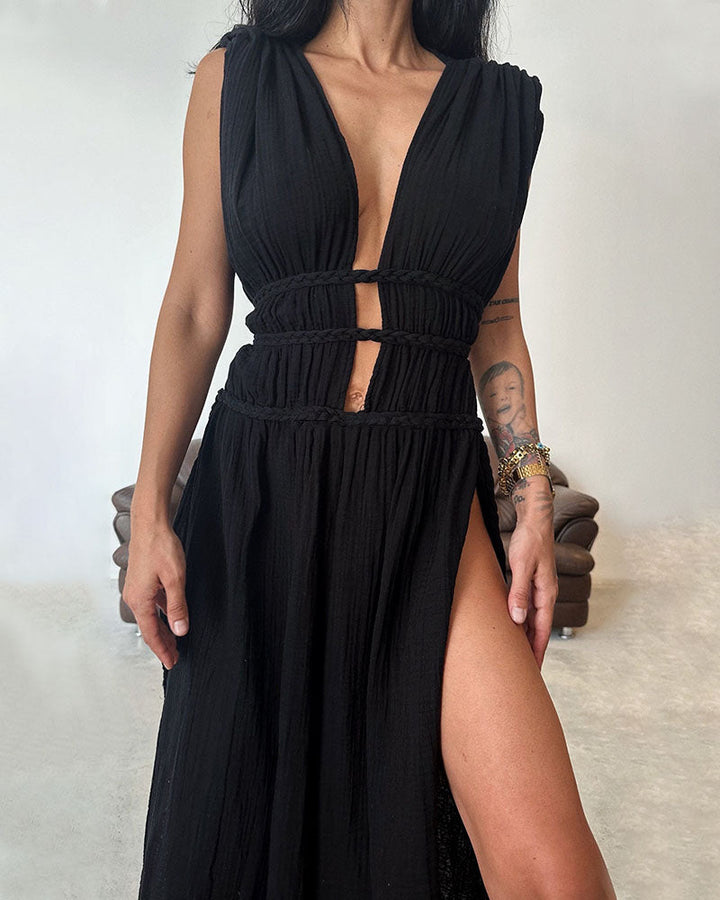 Woman in a softly textured dress with front slit and cinched waist tie at golden hour.