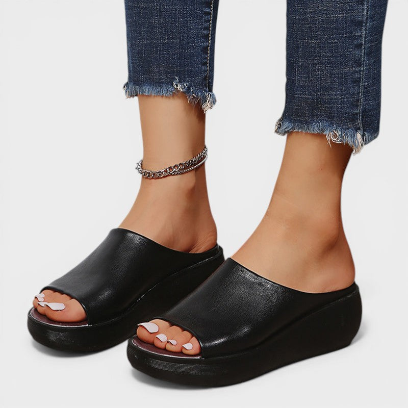 Open wedge mule sandals in white and brown with wide straps and a balanced wedge sole