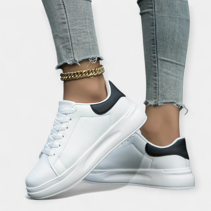 Women's classic white trainers with a clean minimal design and cushioned support sole