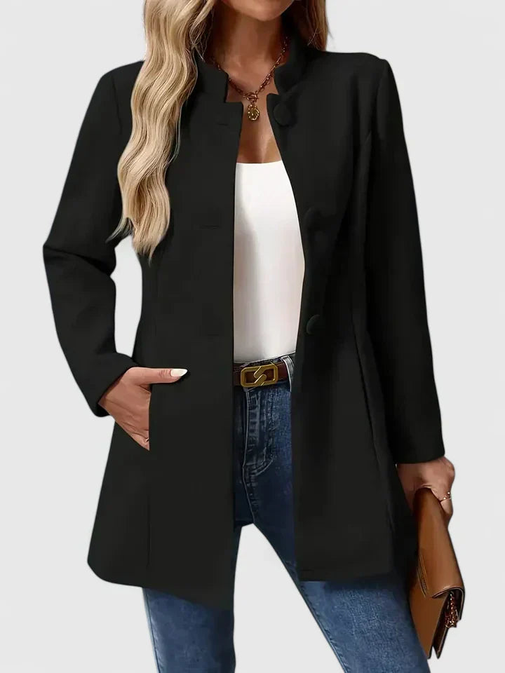 A woman wearing a collarless tailored jacket with a button front