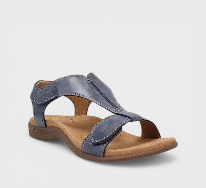 Elegant flat T-bar sandals in black and beige with a classic, refined strap design