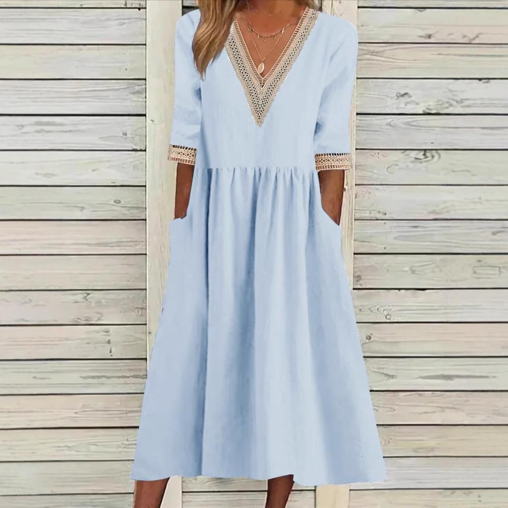 A woman wearing the Deirdre V-neck midi dress with delicate detailing at the collar and sleeves.