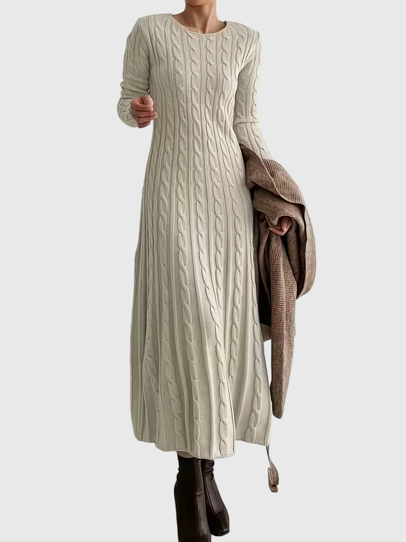 Woman wearing the Laoise cable-texture maxi dress in soft cream, styled with boots.