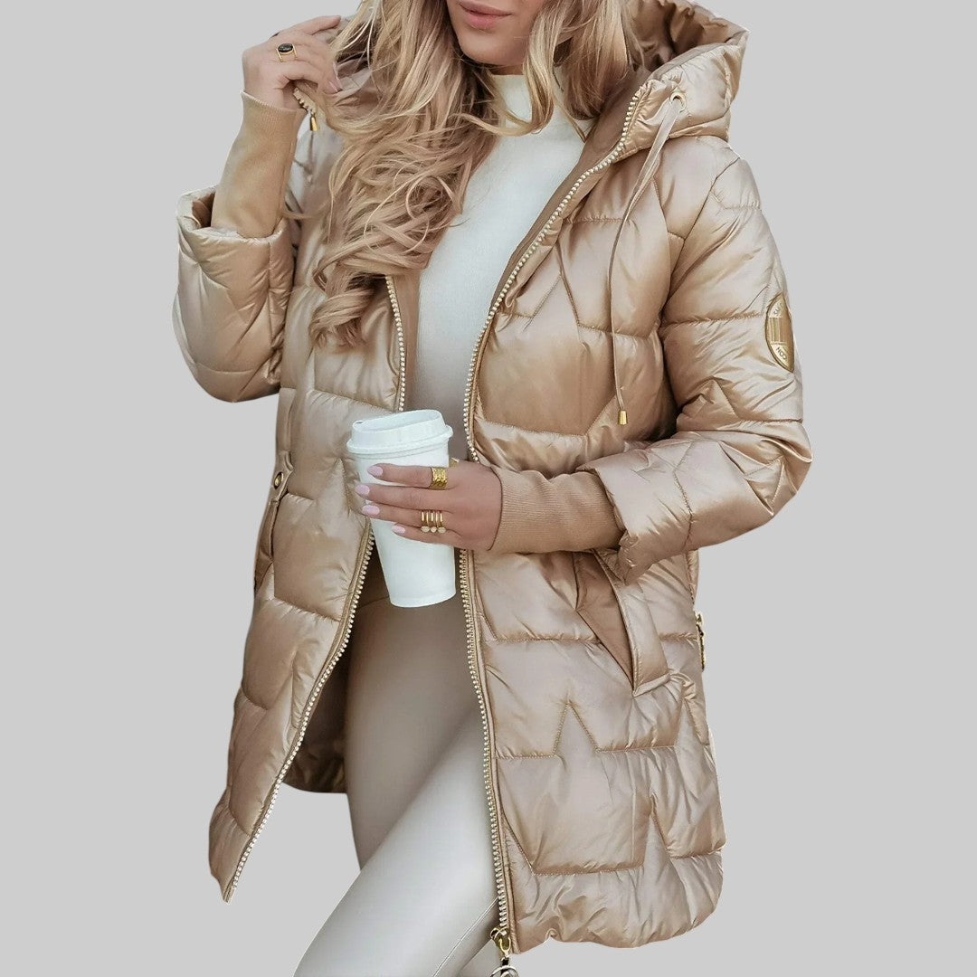 A woman wearing a hooded autumn coat in a timeless tone, sheltered from the wind.