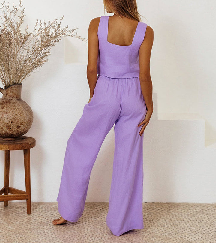 A woman wearing a minimal two-piece set with a square neckline and belted flared trousers.
