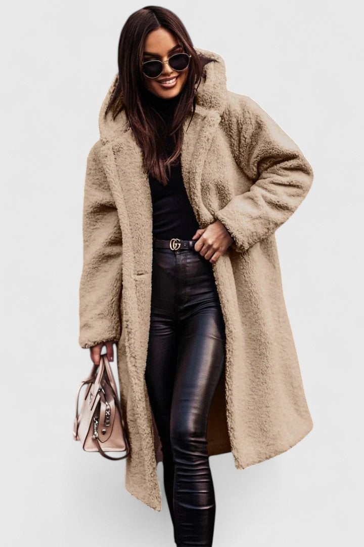 A woman wearing an elegant winter jacket on a cold day in town