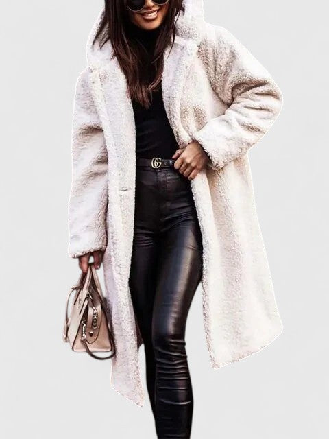 A woman wearing an elegant winter jacket on a cold day in town