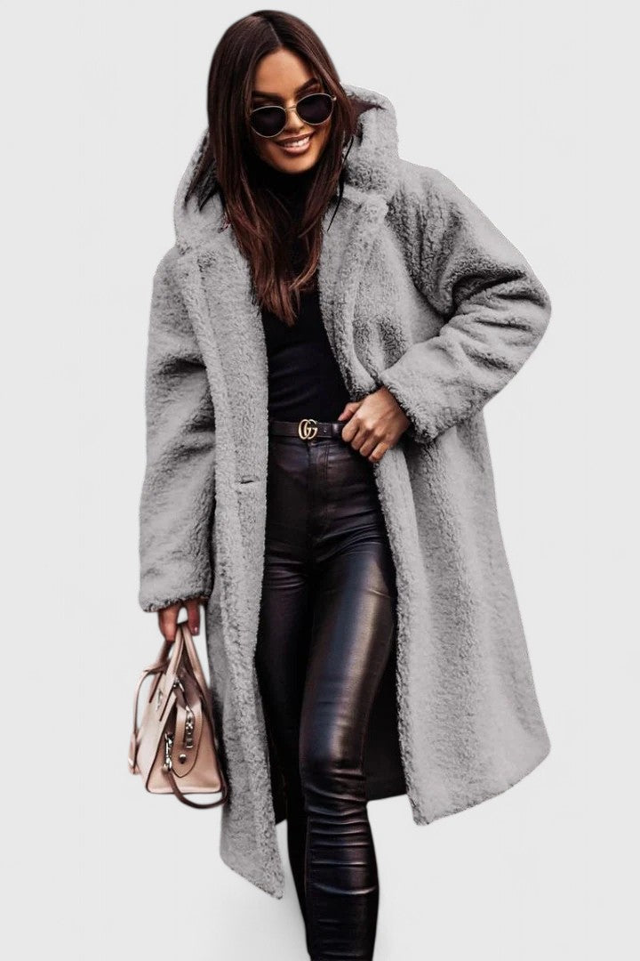 A woman wearing an elegant winter jacket on a cold day in town