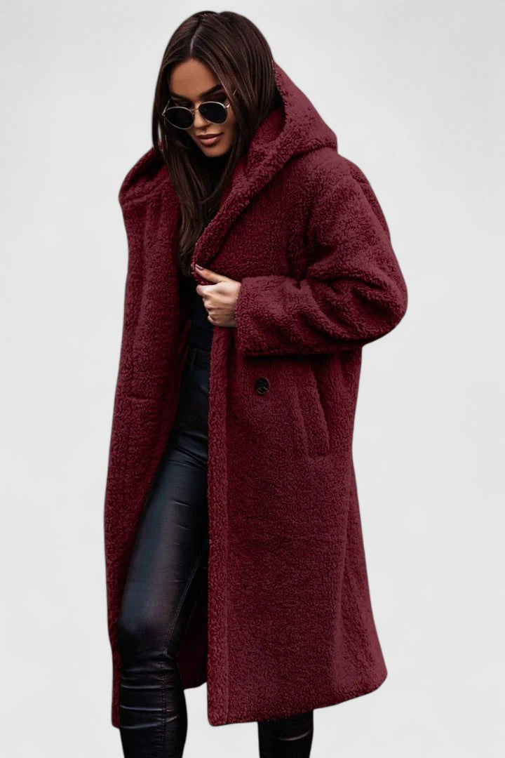 A woman wearing an elegant winter jacket on a cold day in town