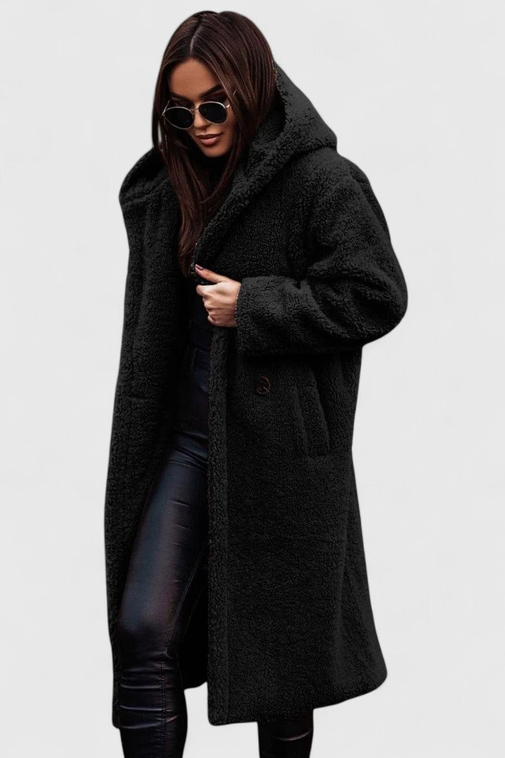 A woman wearing an elegant winter jacket on a cold day in town