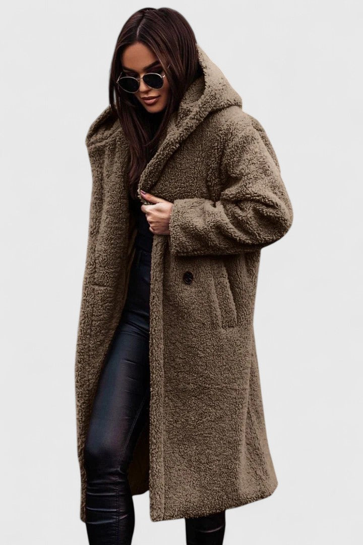 A woman wearing an elegant winter jacket on a cold day in town