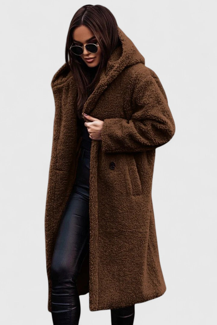 A woman wearing an elegant winter jacket on a cold day in town