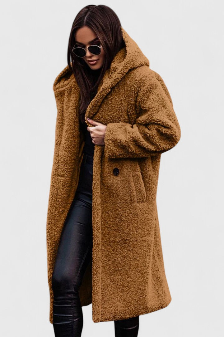 A woman wearing an elegant winter jacket on a cold day in town
