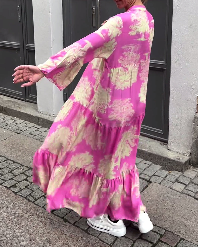 Woman wearing the Abigail flowing maxi dress with a delicate print and V-neckline, the skirt moving softly as she walks.