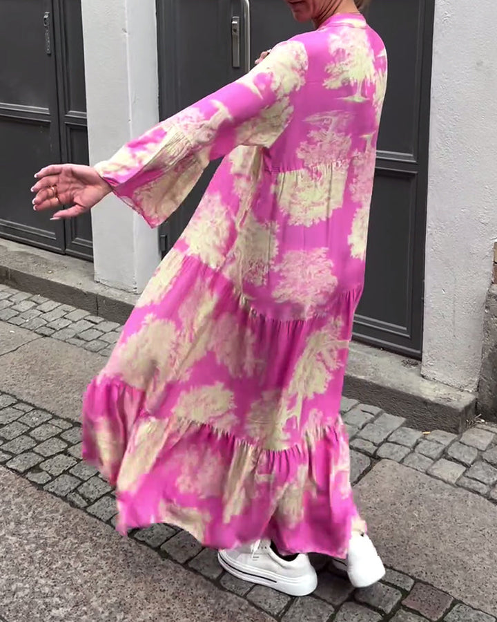Woman wearing the Abigail flowing maxi dress with a delicate print and V-neckline, the skirt moving softly as she walks.