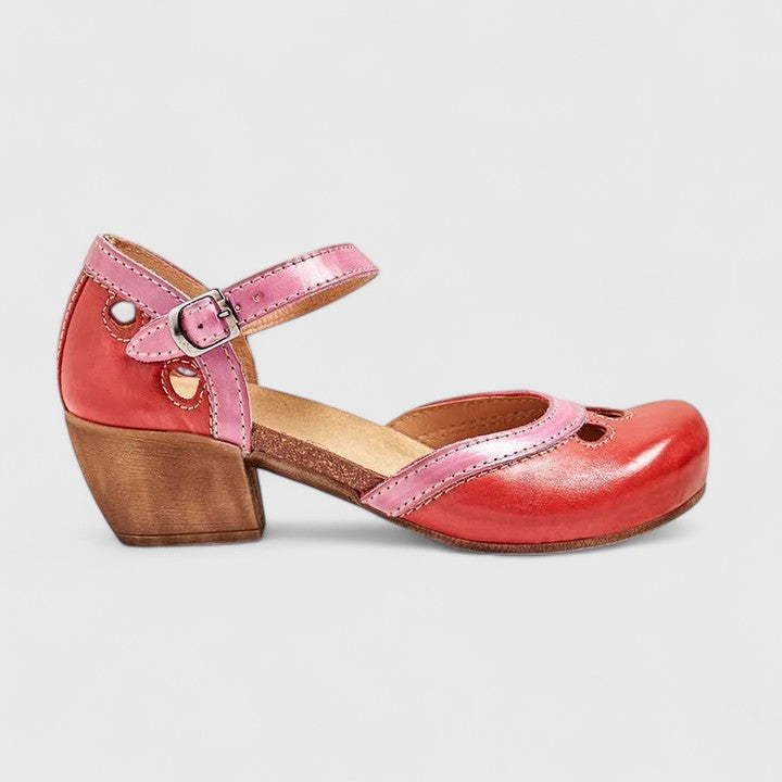 A woman in pastel pink and mint block heel sandals at a summer garden party.