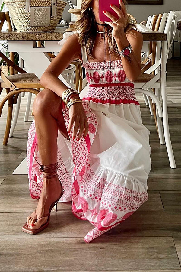 Woman wearing the Teresa™ boho print maxi dress with a gathered bodice, enjoying a warm summer day outdoors.