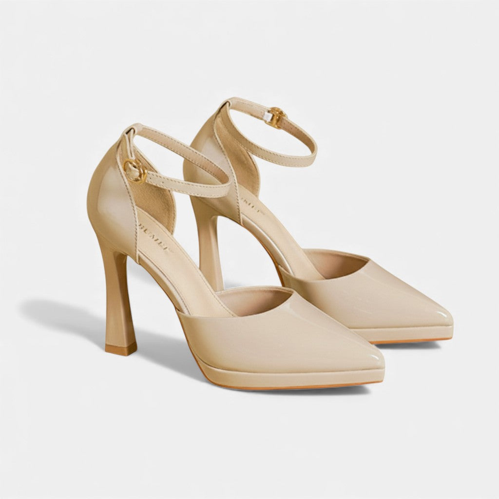 A woman in pointed ankle-strap pumps with a block heel, dressed for a day-to-night occasion.