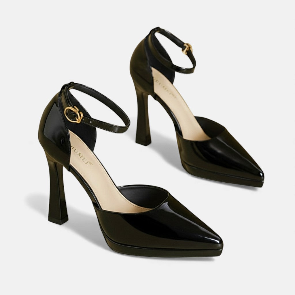 A woman in pointed ankle-strap pumps with a block heel, dressed for a day-to-night occasion.