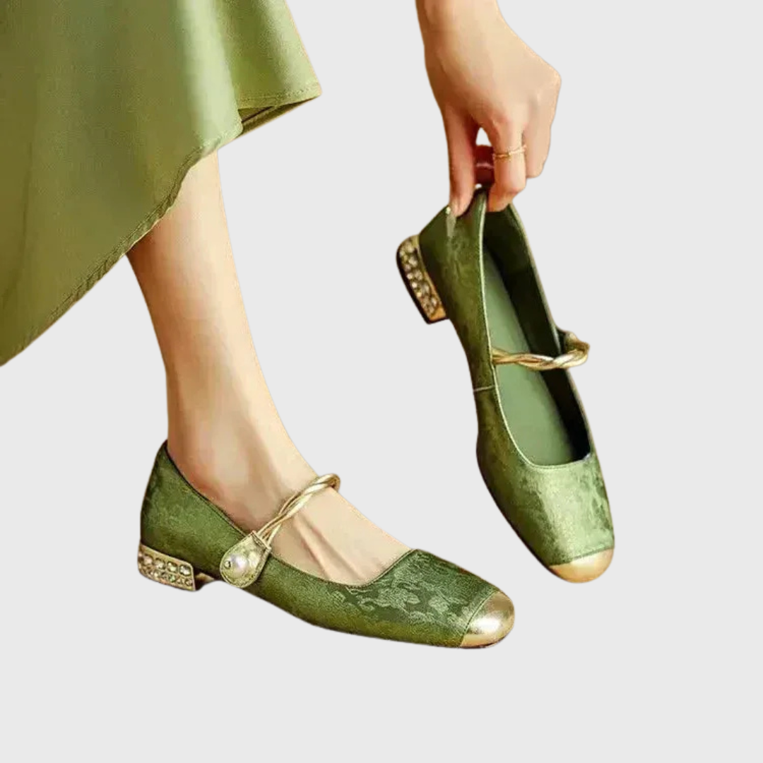 A woman wearing low-heel Mary Janes with a pearl-accented strap and a soft dress