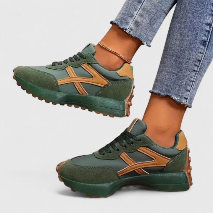 A woman wearing neutral contrast orthopaedic trainers on a city walk.