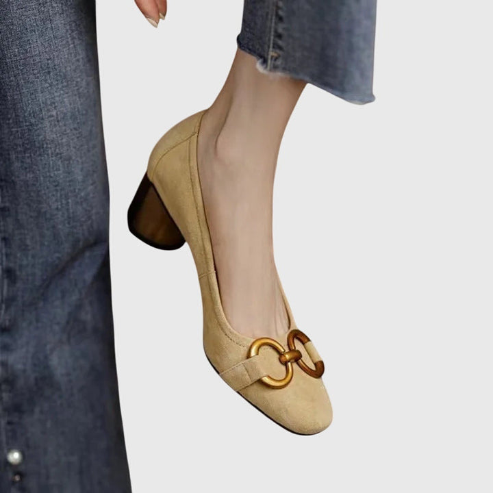 A woman wearing elegant high heels with a tailored evening outfit