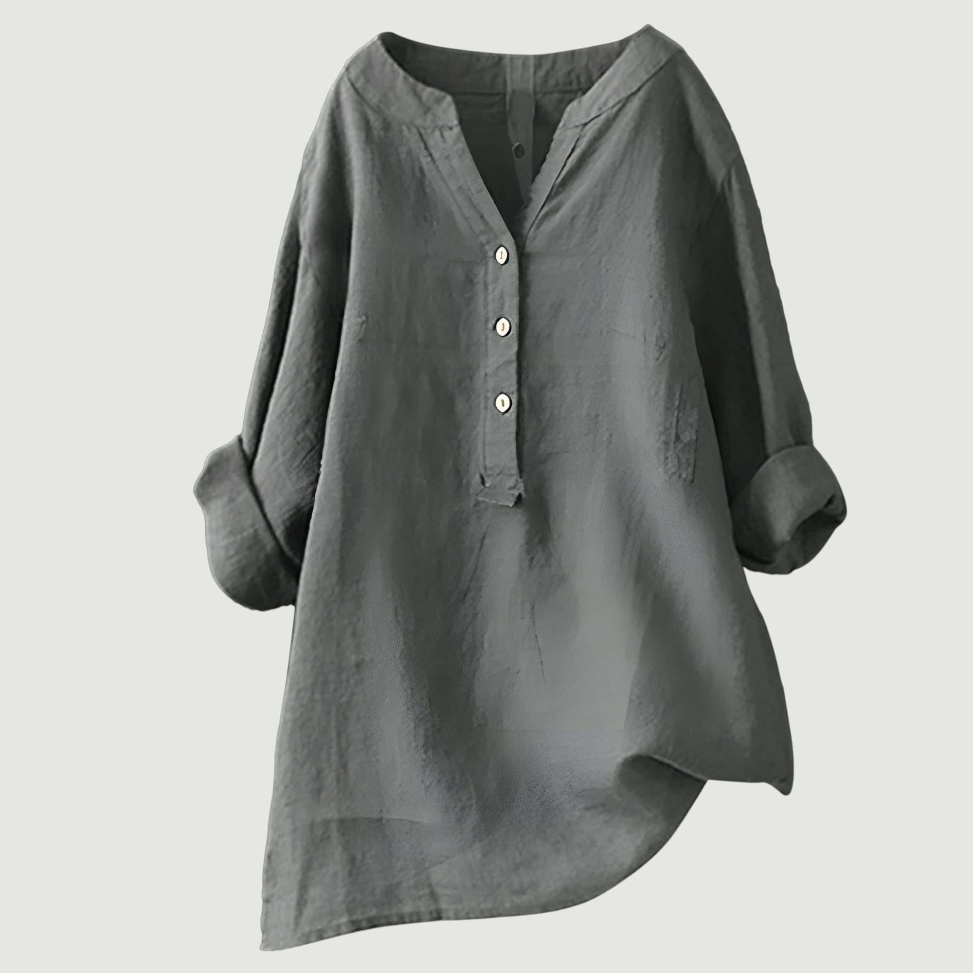A woman wearing a loose button-front tunic top in white with a relaxed draping fit