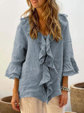 Blue floaty blouse with wide frill sleeves and a relaxed, feminine silhouette