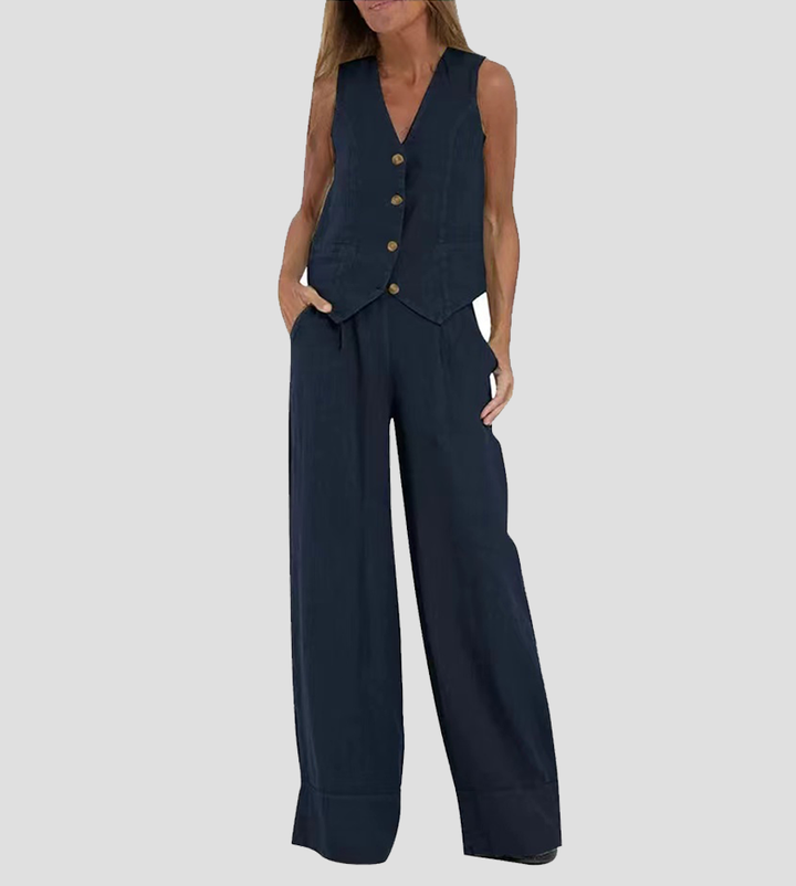 A woman wearing a tailored waistcoat with flowing wide-leg trousers