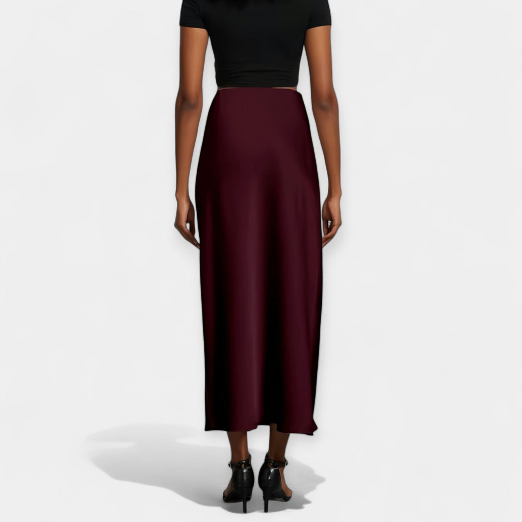 High-waist smooth midi skirt in black with a flowing wide-cut silhouette and lustrous finish