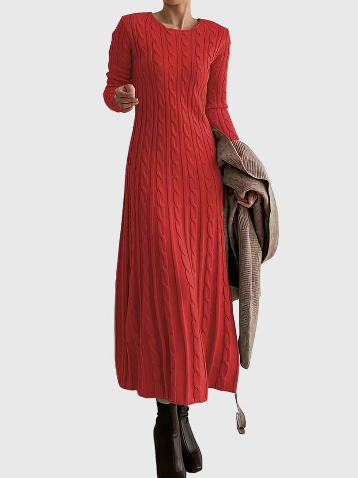 Woman wearing the Laoise cable-texture maxi dress in soft cream, styled with boots.