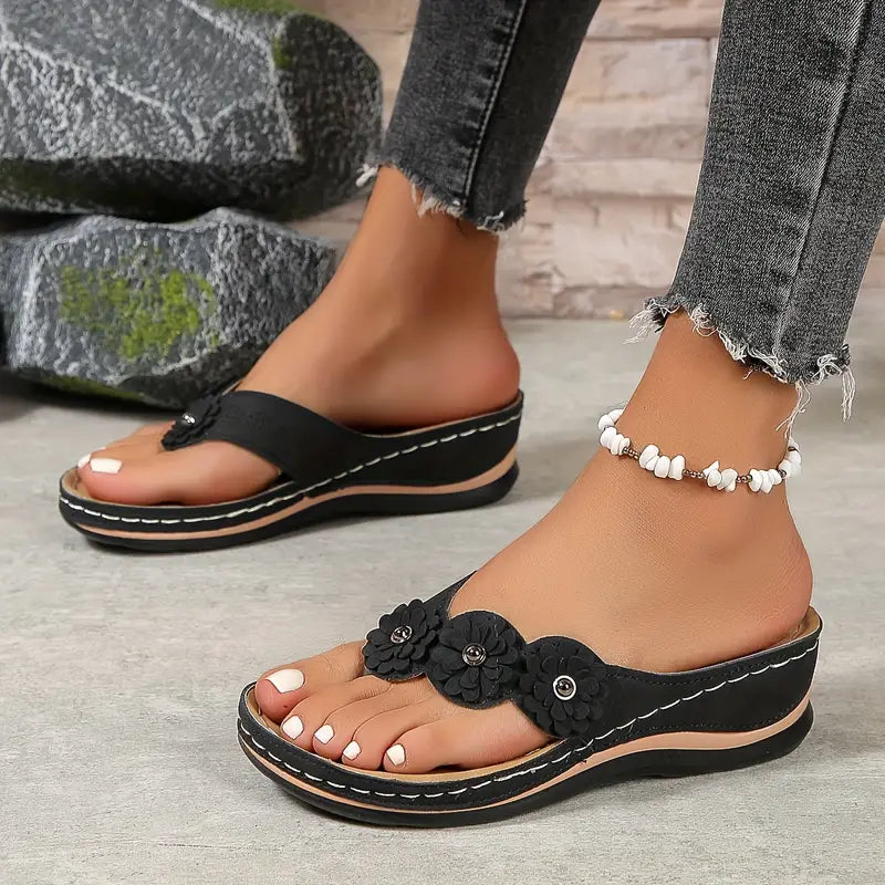 Women's floral toe-post sandals with a soft cushioned base in dark brown, black, navy, red and rose