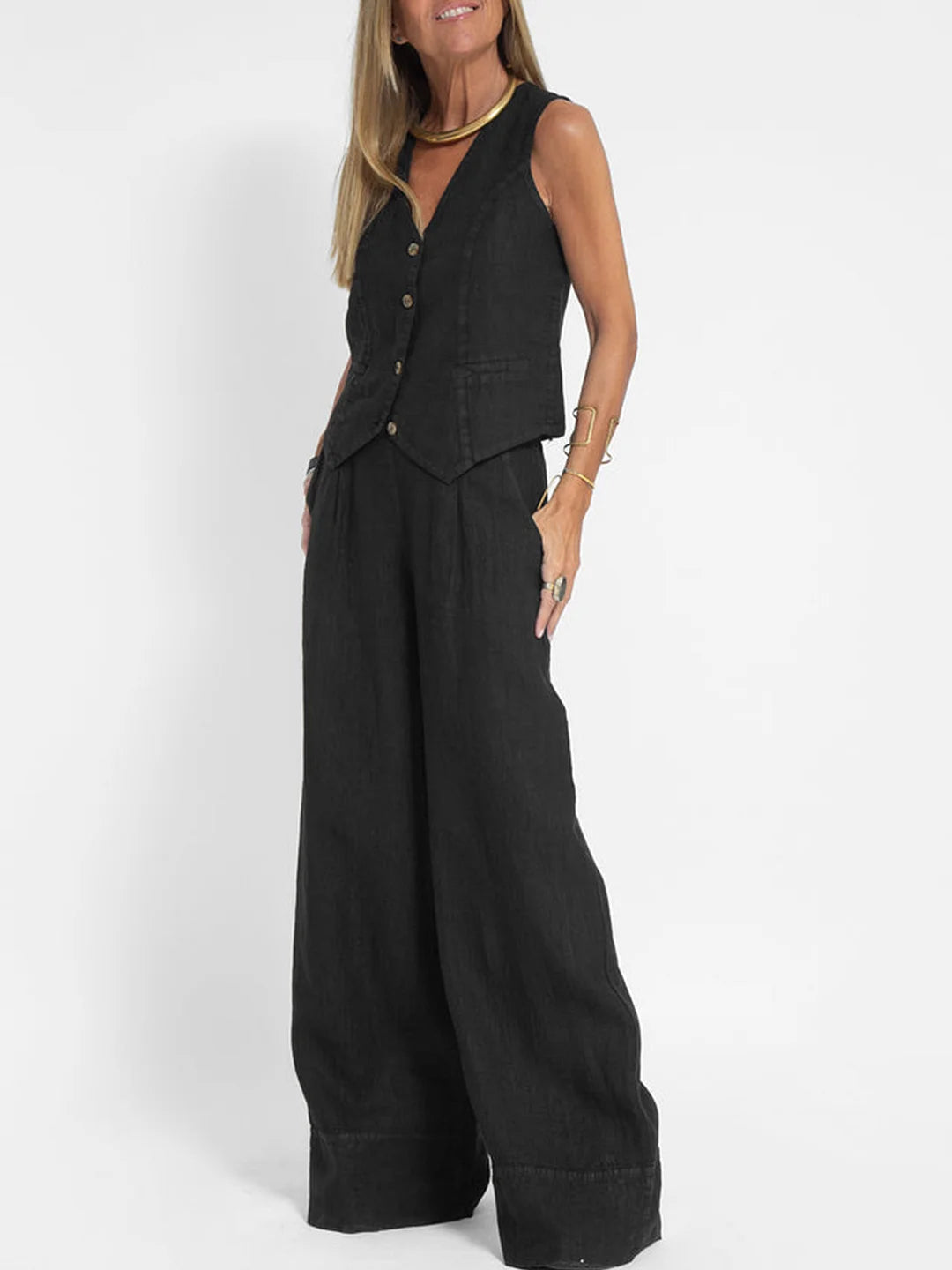 A woman wearing a tailored waistcoat with flowing wide-leg trousers