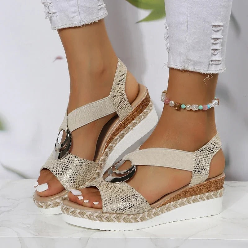 Gold platform sandals with metallic detail and ankle strap