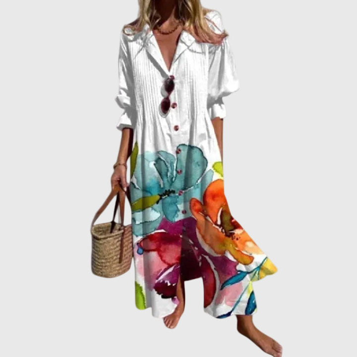Woman in a long flowing boho-style maxi dress with delicate patterns, walking outdoors.
