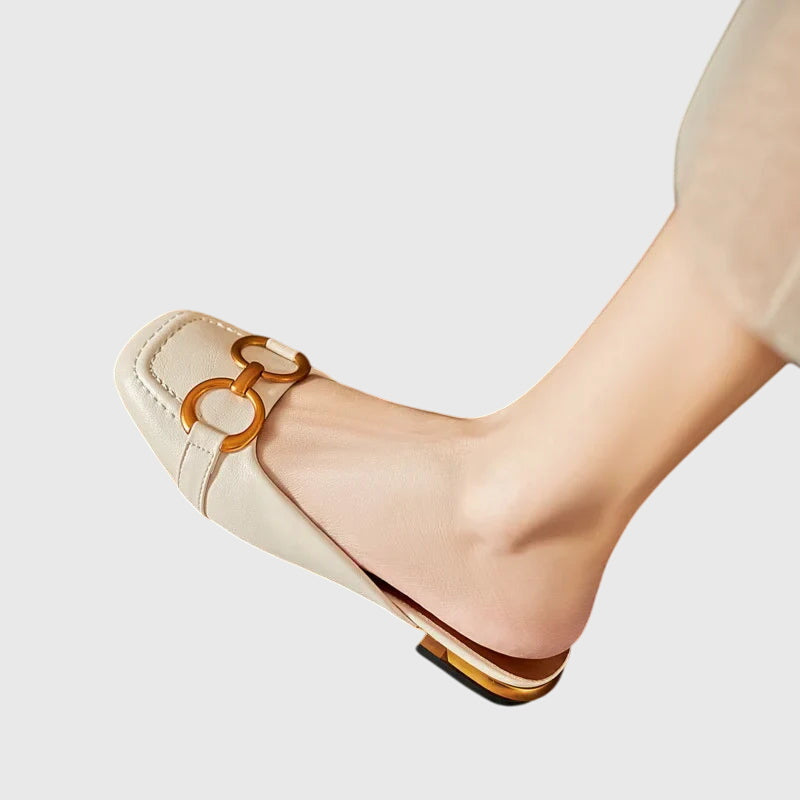 A woman walking easily in beige everyday support sandals with a broad, cushioned footbed.