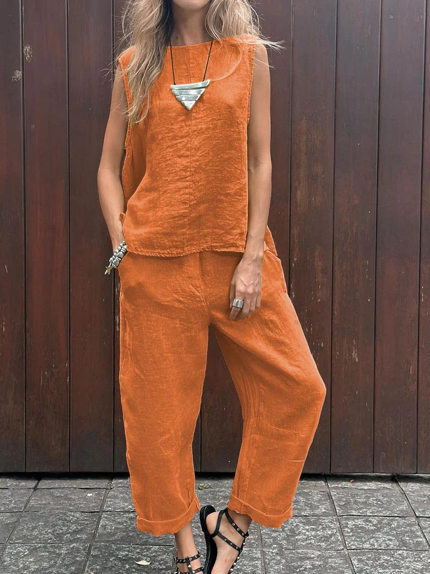 A woman wearing a relaxed sleeveless top with ankle-length trousers, easy and elegant.