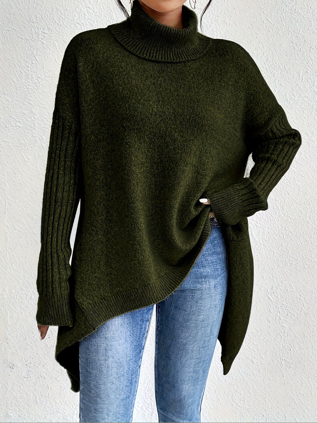 A woman wearing a stand-collar jumper with a chic asymmetric drape, warm and polished.